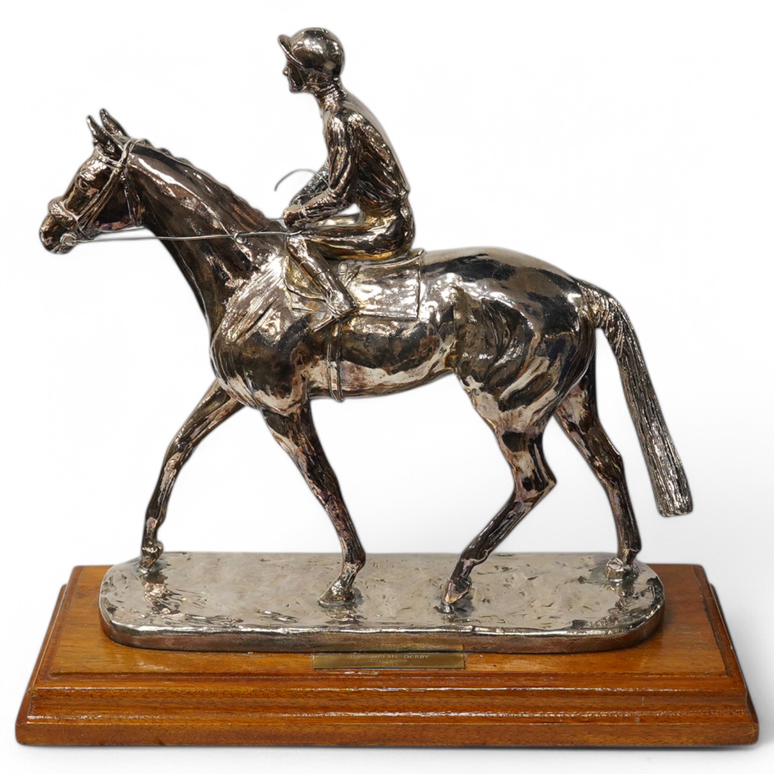 A modern filled silver horse and jockey racing trophy for 'The Welsh Derby, Chepstow, 1986', maker, BJS, London, 1984, mounted on an oak plinth base, height excluding the base 31.5cm. Condition - good